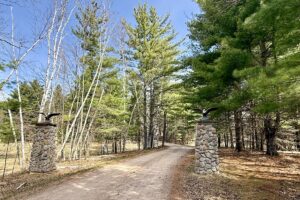 Buildable wooded land for sale in Rusk County near Chetek featuring 287 feet of pond frontage.